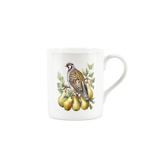 A partridge sat on the branch of a pear tree on a white mug