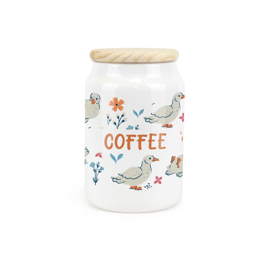 White ceramic canister featuring waddling ducks with a coffee design.