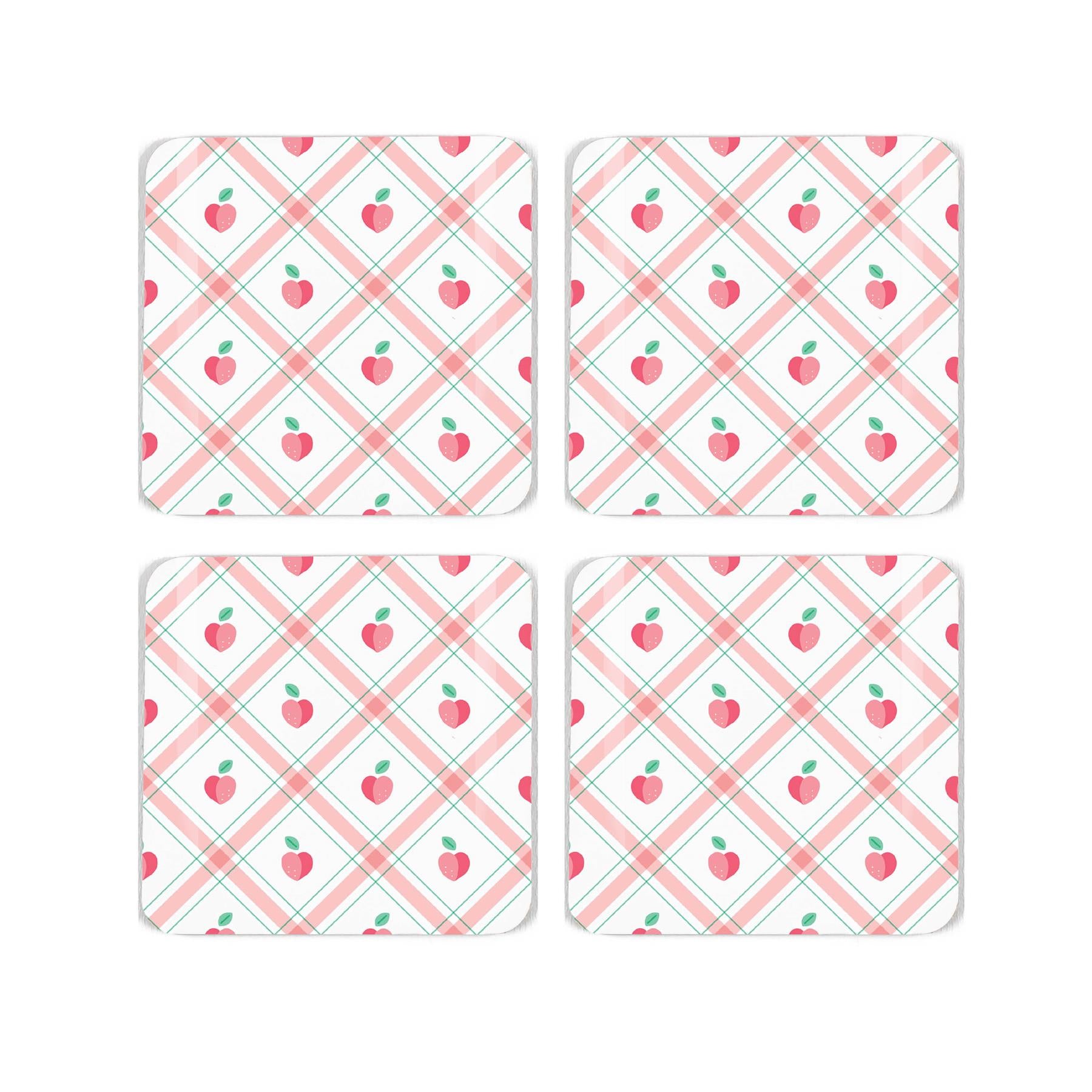 Four square cork coaster with a pretty gingham and peach, repeating design on a white background