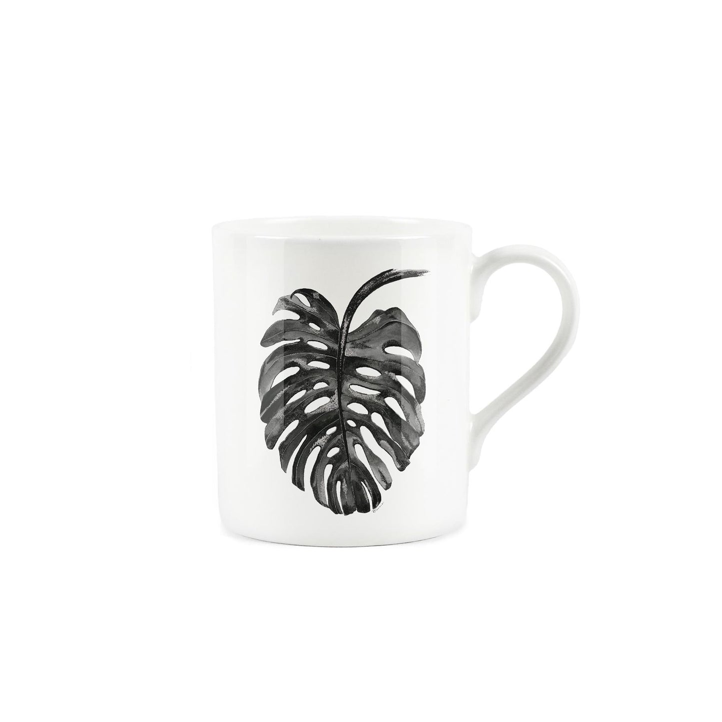 Black Monstera leaf on a white bone china mug.