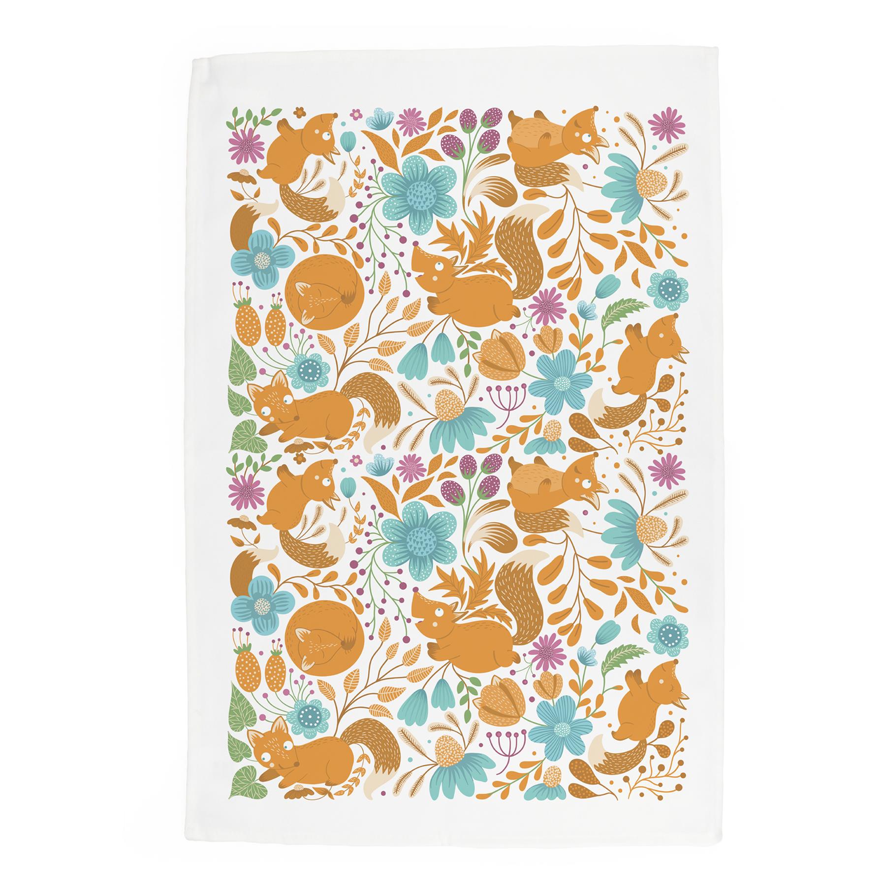 Pattern design featuring cartoon Foxes nestled amongst orange leaves  leaves & pretty wildflowers on a white tea towel
