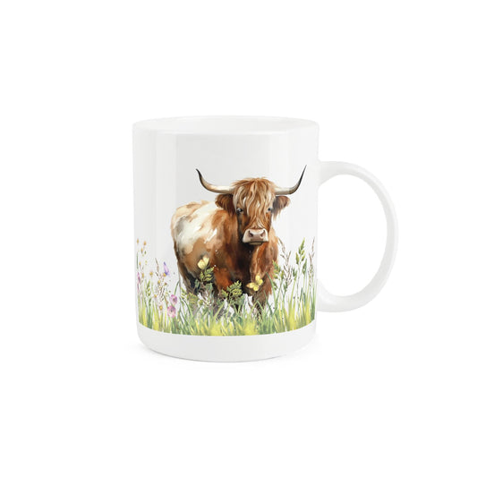 White bone china mug featuring adorable highland cow design standing among grass and flowers.