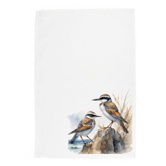 Paterly watercolour depiction of sea birds standing on rocks next to the sea on a white panama cotton tea towel