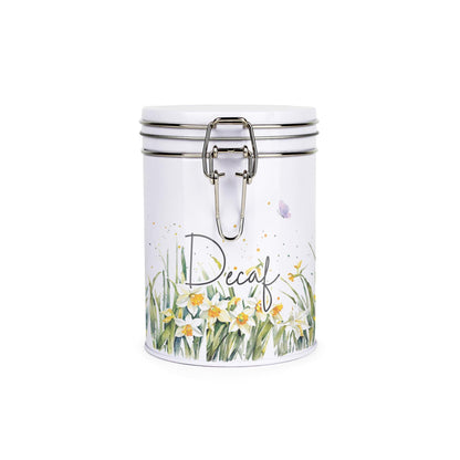 Metal canister with a metal clip and lid featuring a delicate daffodil print with butterflies and dragonflies and coffee text