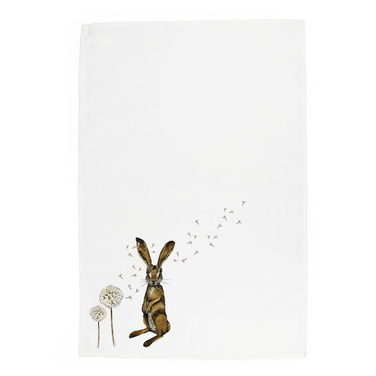 Watercolour depiction of hare stood next to dandeion blowing in the wind printed onto the bottom corner of a tea towel 