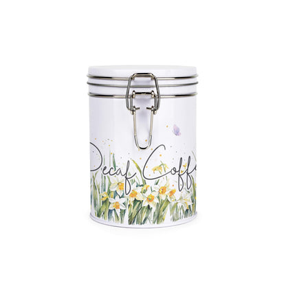 Metal canister with a metal clip and lid featuring a delicate daffodil print with butterflies and dragonflies and decaf text