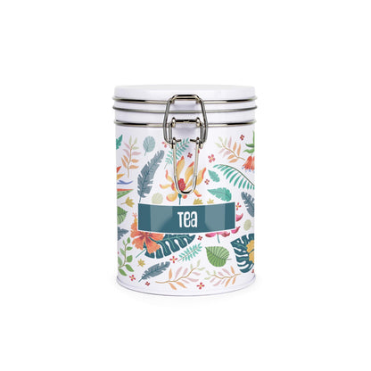 White metal storage canister with metal clip and lid featuring a colourful leaf design on a white background with tea text on front