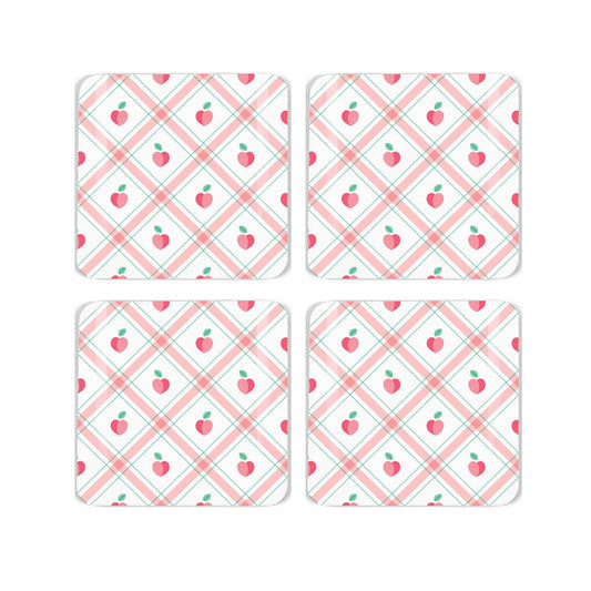 Four square cork coaster with a pretty gingham and peach, repeating design on a white background