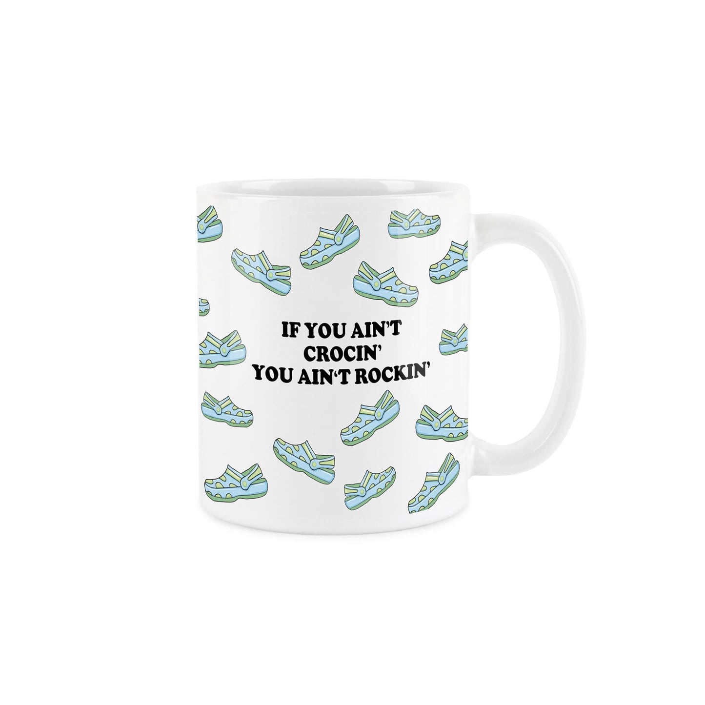 Crocs enthusiast mug: white ceramic covered in blue & green shoes with 'If you ain't rockin' you ain't crocin'.' 325ml capacity, dishwasher-safe.