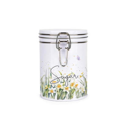 Metal canister with a metal clip and lid featuring a delicate daffodil print with butterflies and dragonflies and hot chocolate text